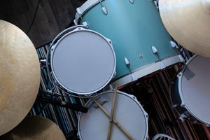 overhead picture of parts of a drum set including snare, tom, bass drum and cymbals